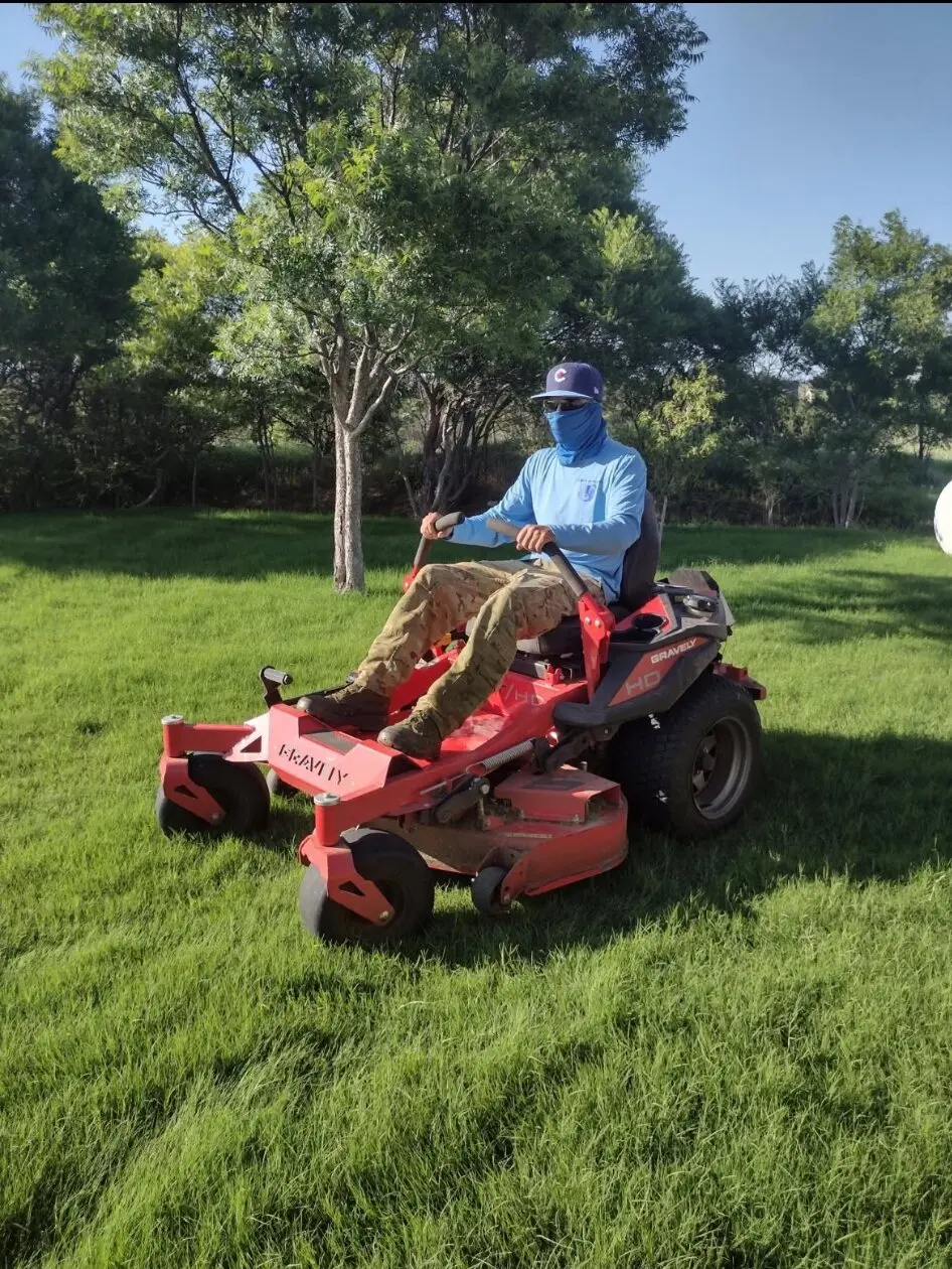 Cubbie Lawn Care owner Karl mowing a residential lawn, featured on his website